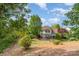 Expansive backyard view with patio, seating, and manicured lawn, offering a serene outdoor retreat at 13406 Ada Ct, Charlotte, NC 28213