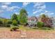 Expansive backyard view with patio, seating, and manicured lawn, offering a serene outdoor retreat at 13406 Ada Ct, Charlotte, NC 28213