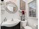 Stylish powder room features a decorative mirror, modern fixtures, and natural light for a refreshing space at 13406 Ada Ct, Charlotte, NC 28213