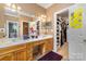 Bathroom with dual sinks, soaking tub, walk-in shower and a walk-in closet for storage at 13406 Ada Ct, Charlotte, NC 28213