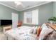 Cozy bedroom featuring crown molding, ceiling fan, and a bright window with natural light at 13406 Ada Ct, Charlotte, NC 28213