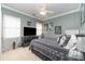 Comfortable bedroom showcasing neutral tones, a modern ceiling fan, and a large window for natural light at 13406 Ada Ct, Charlotte, NC 28213
