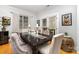 Elegant dining room featuring a dark wood table, upholstered chairs, and natural light at 13406 Ada Ct, Charlotte, NC 28213