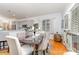 Open-concept dining area with a view of the modern kitchen and light wood floors at 13406 Ada Ct, Charlotte, NC 28213