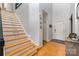 Welcoming foyer featuring wood floors, natural light, stairs and a neutral color palette at 13406 Ada Ct, Charlotte, NC 28213