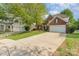 Charming brick two-story home featuring a well-manicured lawn, landscaping, and two car garage at 13406 Ada Ct, Charlotte, NC 28213
