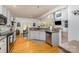 Modern kitchen with white cabinets, stainless steel appliances, and a view of the dining area at 13406 Ada Ct, Charlotte, NC 28213