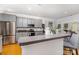 Well-lit kitchen with grey cabinetry, stainless steel appliances, and ample counter space at 13406 Ada Ct, Charlotte, NC 28213