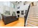 Bright living room with hardwood floors, fireplace, staircase, and soaring windows at 13406 Ada Ct, Charlotte, NC 28213