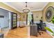 Bright home office boasts hardwood floors, modern lighting fixture and sophisticated decor to inspire productivity and creativity at 13406 Ada Ct, Charlotte, NC 28213