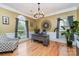 Bright home office with a large desk, accent chair, and natural light from the windows at 13406 Ada Ct, Charlotte, NC 28213