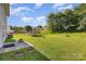 A spacious backyard features a trampoline and a basketball court for recreation and entertainment at 1346 Mandy Place Ct, Charlotte, NC 28216