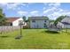 A backyard features a trampoline and basketball court, ideal for Gathering fun and entertainment at 1346 Mandy Place Ct, Charlotte, NC 28216