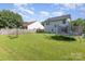 An expansive backyard offers ample space for outdoor activities, featuring a trampoline and basketball hoop at 1346 Mandy Place Ct, Charlotte, NC 28216