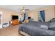 Spacious bedroom with two windows, ceiling fan, and carpeted flooring at 1346 Mandy Place Ct, Charlotte, NC 28216