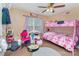 bedroom with a bunk bed, desk, a window, and a ceiling fan at 1346 Mandy Place Ct, Charlotte, NC 28216