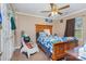 bedroom includes a ceiling fan, desk, and well-made bed at 1346 Mandy Place Ct, Charlotte, NC 28216