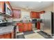 The kitchen features tile flooring, wood cabinets, stainless steel appliances, and a window at 1346 Mandy Place Ct, Charlotte, NC 28216
