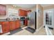 The kitchen has stainless steel appliances, tile flooring, and wood cabinets at 1346 Mandy Place Ct, Charlotte, NC 28216