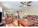 Inviting living room featuring hardwood floors, plush seating, and a ceiling fan at 1346 Mandy Place Ct, Charlotte, NC 28216