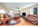 Inviting living room featuring hardwood floors, plush seating, and a ceiling fan at 1346 Mandy Place Ct, Charlotte, NC 28216