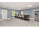 Basement bar area with refrigerator, bar seating, and an exterior door at 14834 Pawnee Trl, Matthews, NC 28104