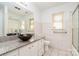 Updated bathroom featuring a granite vanity, unique bowl sink, and updated walk-in shower at 14834 Pawnee Trl, Matthews, NC 28104
