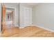 Bedroom with hardwood floors, closet, neutral paint, and doorway to additional rooms at 14834 Pawnee Trl, Matthews, NC 28104