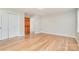 Bedroom with hardwood floors, closet, neutral paint, and doorway to additional rooms at 14834 Pawnee Trl, Matthews, NC 28104