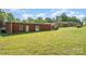 Large metal outbuilding with a big, grassy lawn and a connecting patio to the house at 14834 Pawnee Trl, Matthews, NC 28104