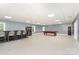 Open game room with a bar, refrigerator, bar seating, and pool table at 14834 Pawnee Trl, Matthews, NC 28104