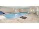 Relax in this spacious indoor pool area with hot tub, lounge chairs, and bright lighting at 14834 Pawnee Trl, Matthews, NC 28104