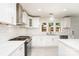 Well-lit kitchen with modern white cabinetry, stainless steel appliances, and light tile flooring at 14834 Pawnee Trl, Matthews, NC 28104