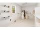 Functional laundry room with storage shelves and a window for natural light at 14834 Pawnee Trl, Matthews, NC 28104
