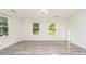 Bright living room with updated floors featuring two large sunny windows at 14834 Pawnee Trl, Matthews, NC 28104
