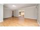 Spacious living room with hardwood floors, a sliding glass door to the outside, and neutral wall paint at 14834 Pawnee Trl, Matthews, NC 28104