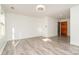Spacious living room featuring light gray hardwood floors and natural light at 14834 Pawnee Trl, Matthews, NC 28104