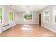 Bright living room with hardwood floors, large windows, modern lighting, and neutral paint at 14834 Pawnee Trl, Matthews, NC 28104