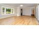 Bright living room with wood floors, large windows offering picturesque view, and contemporary lighting at 14834 Pawnee Trl, Matthews, NC 28104