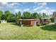 Backyard featuring a metal outbuilding, grassy lawn, and a covered patio at 14834 Pawnee Trl, Matthews, NC 28104