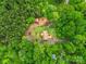 Overhead view of a home nestled amongst lush greenery featuring an above-ground pool and red outbuilding at 1534 Buffalo Shoals Rd, Lincolnton, NC 28092