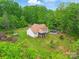 Aerial view of a secluded home with a pool, screened porch, and lush green surroundings at 1534 Buffalo Shoals Rd, Lincolnton, NC 28092