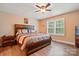 Cozy bedroom with wood-look floors, ceiling fan, and large window with natural light at 1534 Buffalo Shoals Rd, Lincolnton, NC 28092
