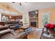 Open-concept living room with a stone fireplace, large leather couches, and views into the kitchen at 1534 Buffalo Shoals Rd, Lincolnton, NC 28092