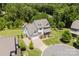 Aerial view of a well-maintained home boasting a three-car garage and manicured landscaping at 15431 Cimarron Hills Ln, Charlotte, NC 28278