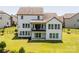 Exterior elevation showcasing a well-manicured lawn, a covered patio, and a second-story screened porch at 15431 Cimarron Hills Ln, Charlotte, NC 28278