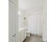 Well-lit bathroom boasts clean, white fixtures, a shower-tub combo, and modern tile flooring at 15431 Cimarron Hills Ln, Charlotte, NC 28278