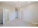 Spacious bedroom with neutral carpet, chandelier lighting, and adjacent closet at 15431 Cimarron Hills Ln, Charlotte, NC 28278