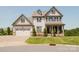 Charming two-story home with a manicured lawn, covered porch, and attached two-car garage at 15431 Cimarron Hills Ln, Charlotte, NC 28278