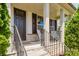 Inviting covered front porch with stone accents and decorative columns perfect for relaxing outdoors at 15431 Cimarron Hills Ln, Charlotte, NC 28278